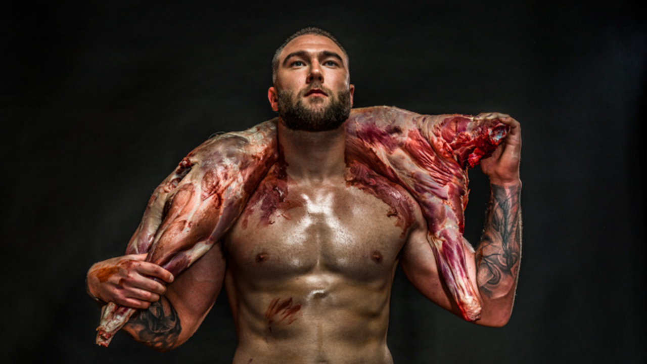 League player Curtis Sironen poses with raw meat