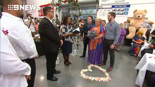 Blushing bride walks down the tyre aisle for dream Costco wedding