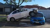 Toyota lands on top of parked car after Adelaide crash